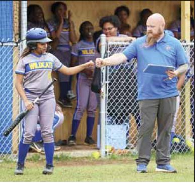 Kemper County softball coach Freddy Thomas gives a little encouragement to on-deck hitter Beverly Billy during last week’s action.